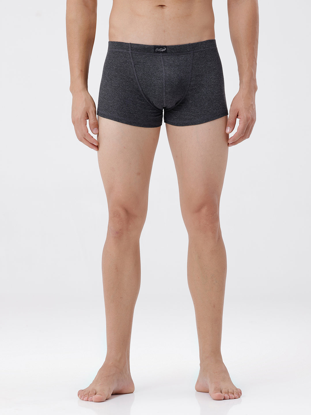 Person wearing dark gray boxer briefs on a white background