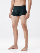 Person wearing black boxer briefs on a white background