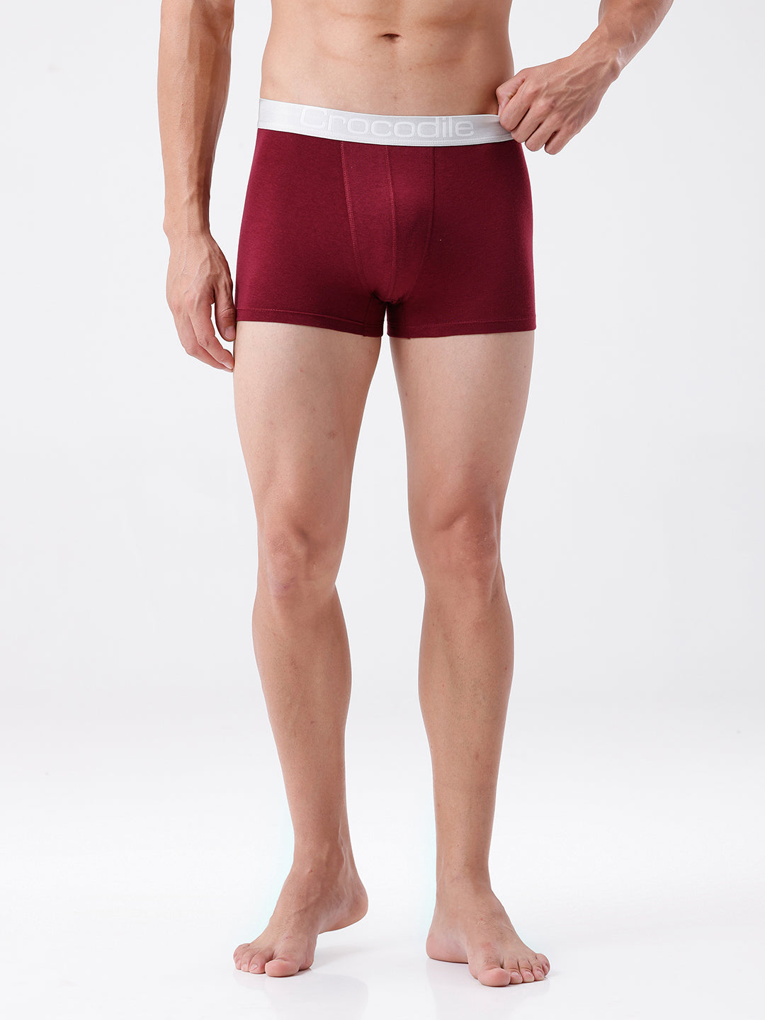 Person wearing maroon boxer briefs on a white background