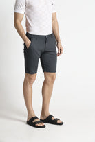 Person wearing gray shorts and a white shirt on a white background