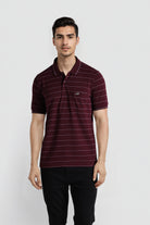 Man wearing a maroon striped polo shirt on a white background