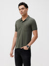 Man wearing a self structure solid polo t shirt with casual styling on a gray background
