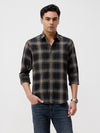 Man wearing a olive oxford checks shirt olive with casual styling on a gray background