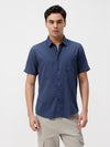 Man wearing a blue melange shirt solid blue on a light gray background