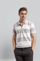 Man wearing a striped polo shirt against a plain background