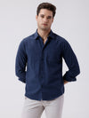 Man wearing a blue melange shirt blue on a light gray background