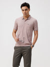 Man wearing a pink self structure solid polo t shirt pink with casual styling on a gray background