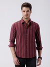 Man wearing a red cozy textured bold stripe shirt on a light gray background