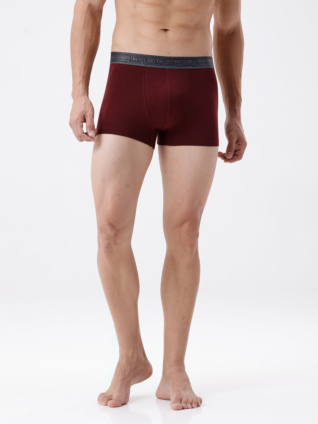 Man wearing maroon boxer briefs with a white background