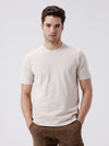 Man wearing a beige classic stretch crewn neck t shirt beige with casual styling on a gray background