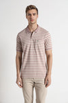 Man wearing a pink pink striper polo t shirt comfort fit polo t shirt on a light gray background