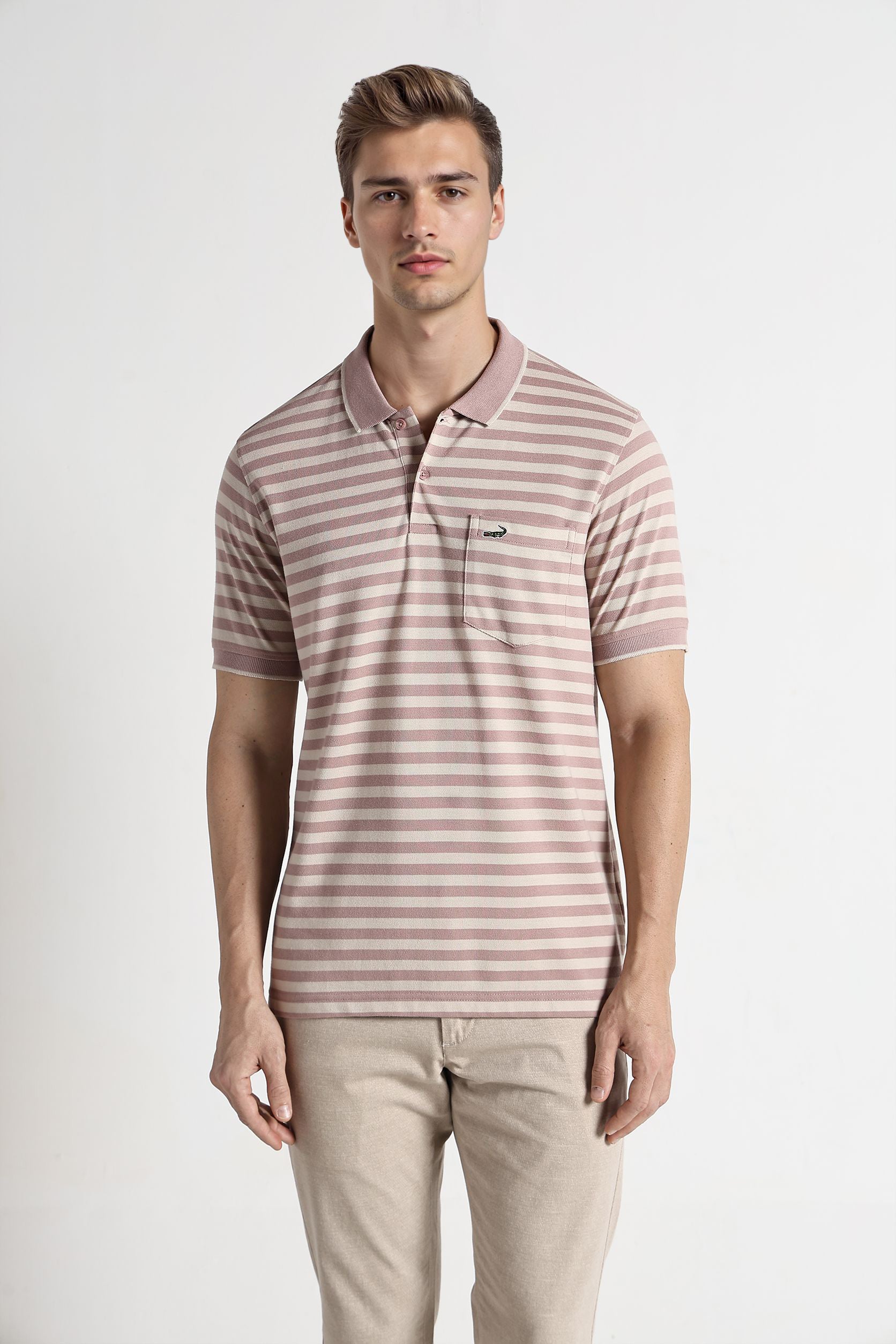 Man wearing a striped polo shirt and beige pants on a white background