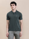Man wearing a green solid polo t shirt green melange with pocket with casual styling on a gray background