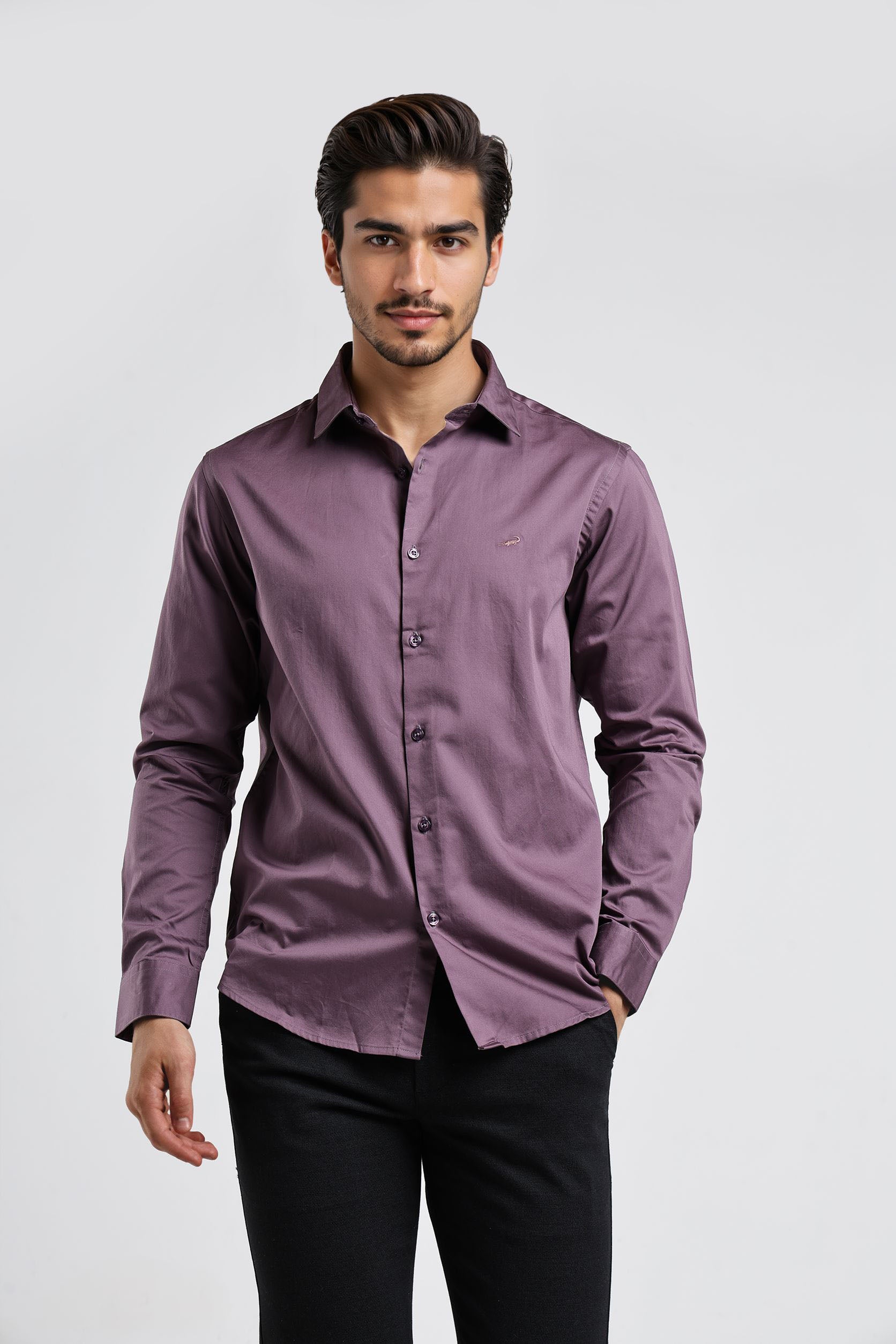 Man wearing a purple shirt and black pants on a white background