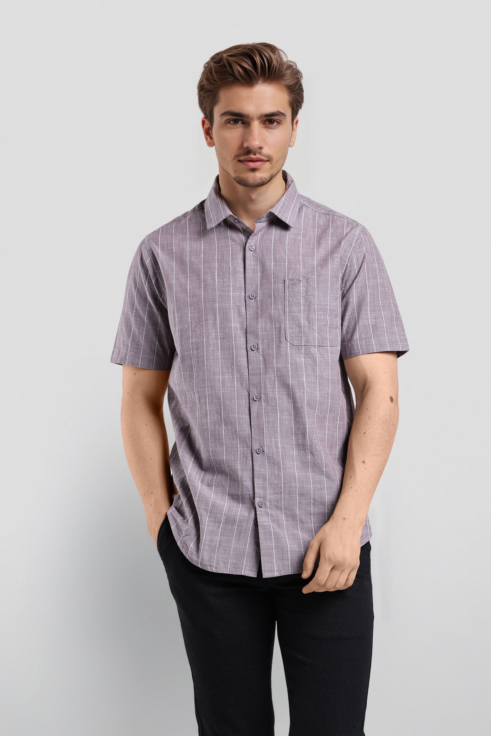 Man wearing a purple checkered shirt against a white background