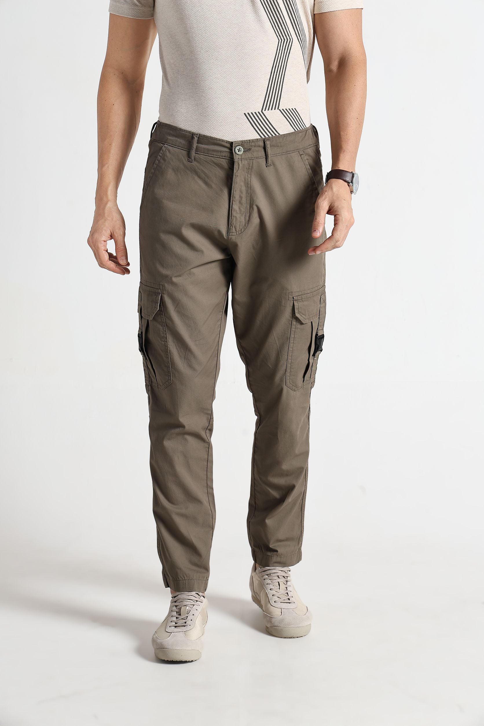Person wearing brown cargo pants on a white background