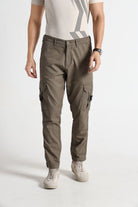 Person wearing brown cargo pants on a white background
