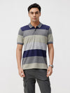 Man wearing a navy navy striper comfort fit polo t shirt with casual styling on a gray background