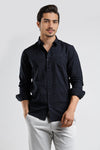 Man wearing a navy navy self emboss checks cotton v-shape pocket comfort fit shirts on a light gray background