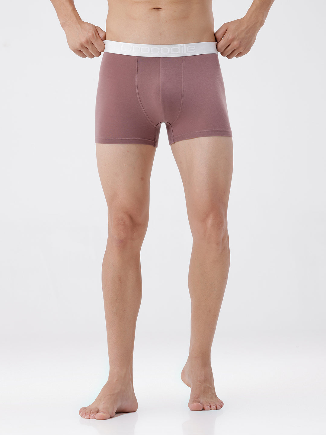 Person wearing mauve boxer briefs with white waistband on a white background