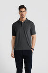 Man wearing a grey grey solid polo t shirt slim fit polo t shirt with casual styling on a gray background
