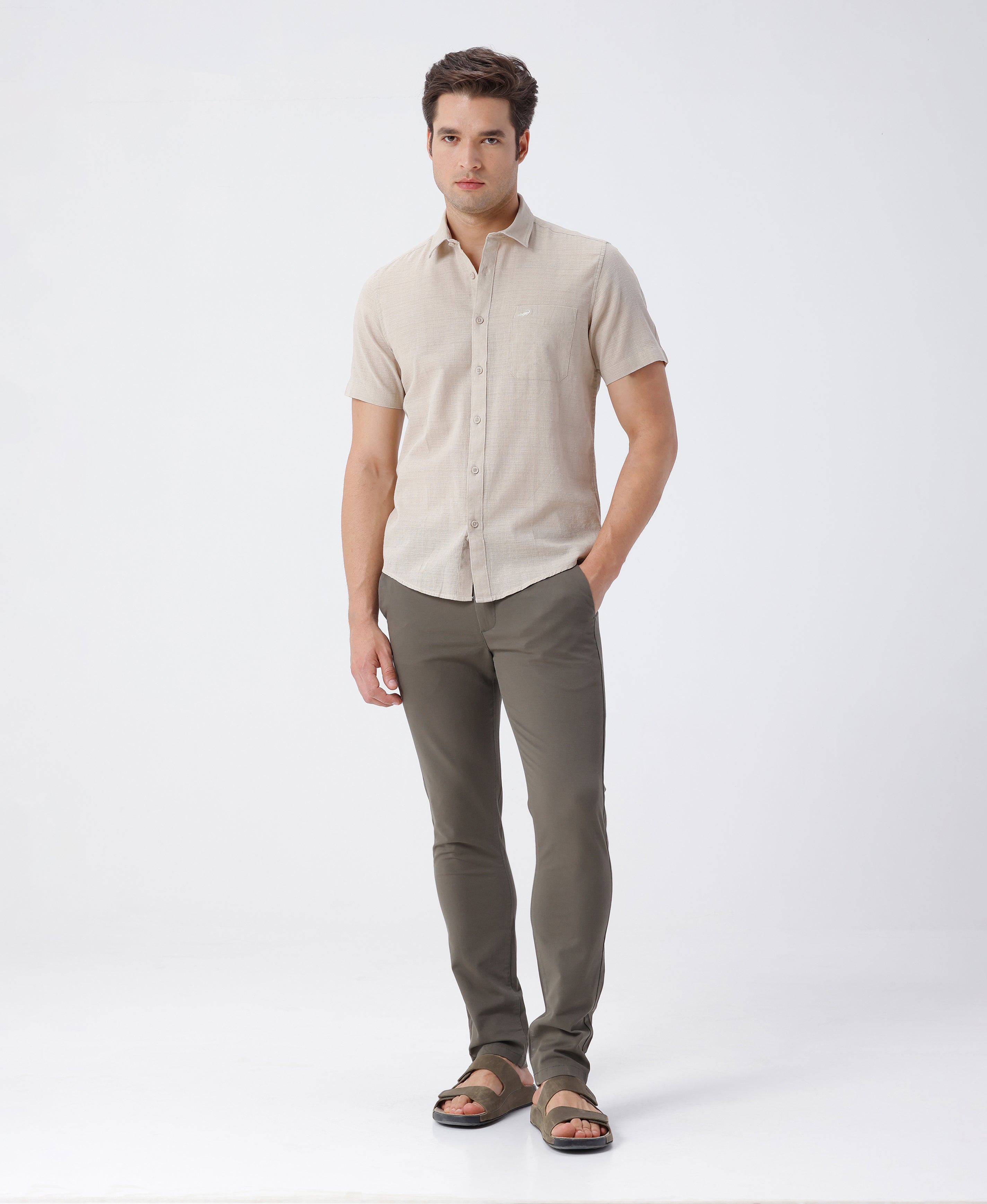 Man wearing a beige pure cotton textured shirt beige on a light gray background