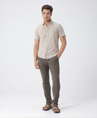Man wearing a beige pure cotton textured shirt beige on a light gray background