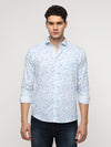 Man wearing a blue blue abstrct premium printed shirt with casual styling on a gray background