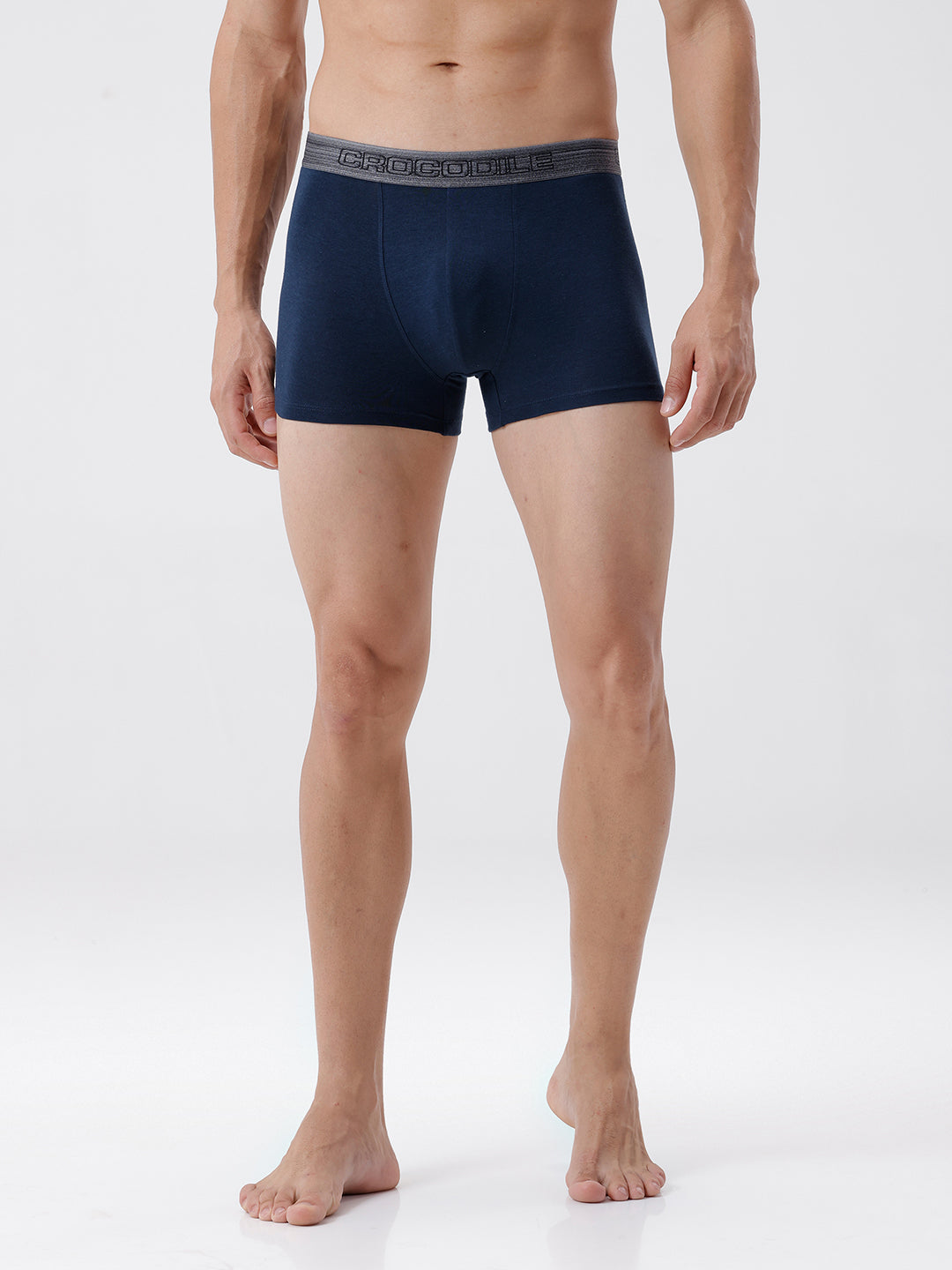 Man wearing navy blue boxer briefs on a white background