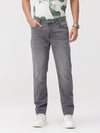 Man wearing a grey grey twill slim fit jeans on a light gray background