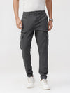 Man wearing a dark shadow solid jogger fit joggers on a light gray background