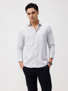 Man wearing a white white all over print slim fit casuals shirts with casual styling on a gray background