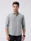 Man wearing a green premium tensil linen shirt dark green on a light gray background