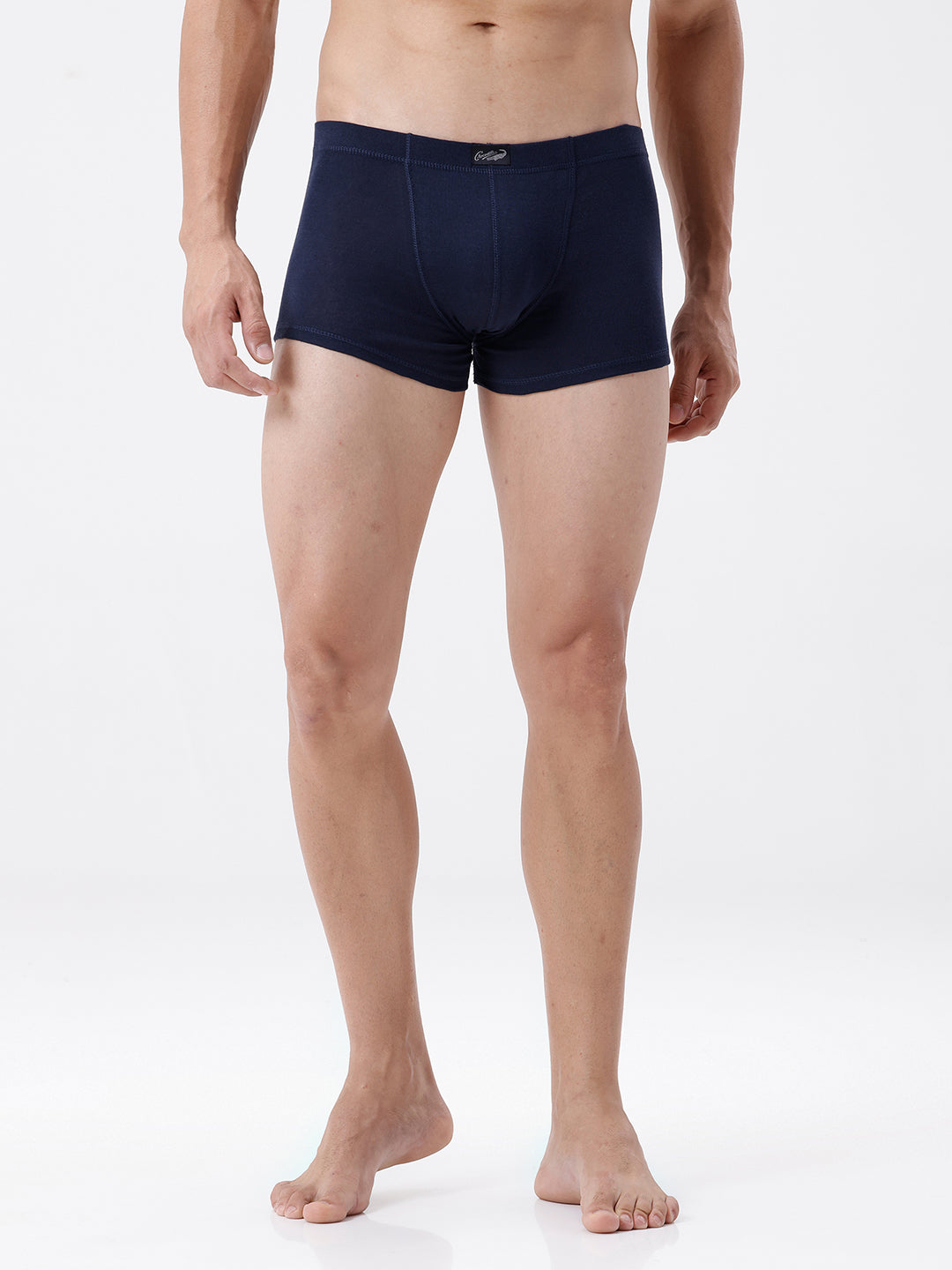 Man wearing navy blue boxer briefs on a white background