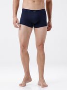 Man wearing navy blue boxer briefs on a white background