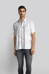 Man wearing a green green fluid shirt grunge print relax fit relaxed fit shirts on a light gray background