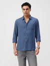 Man wearing a navy premium tensil linen shirt navy on a light gray background