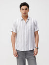 Man wearing a white white and green stripes comfort fit casuals shirts on a light gray background