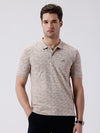 Man wearing a all over printed subtle texture polo t shirt on a light gray background