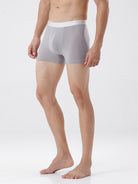 Person wearing gray boxer briefs on a white background
