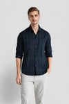 Man wearing a navy navy geometric horizontal self stripe cotton viscose fabric comfort fit shirts on a light gray background