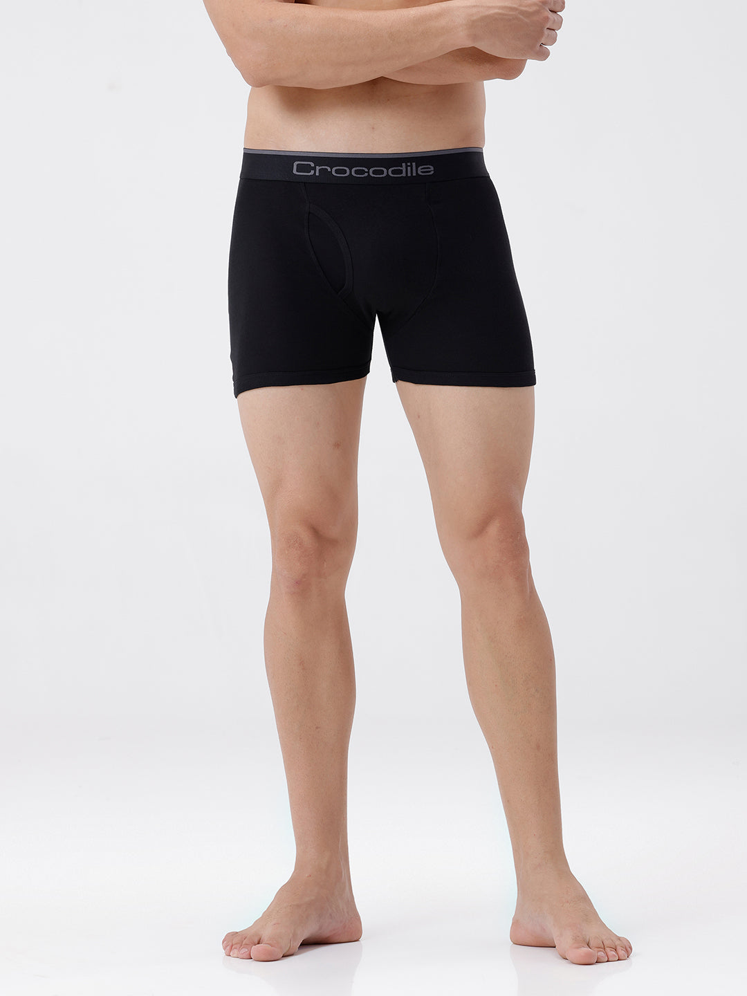 Person wearing black boxer briefs with a visible brand logo on a white background