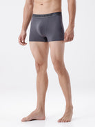 Man wearing gray boxer briefs on a white background