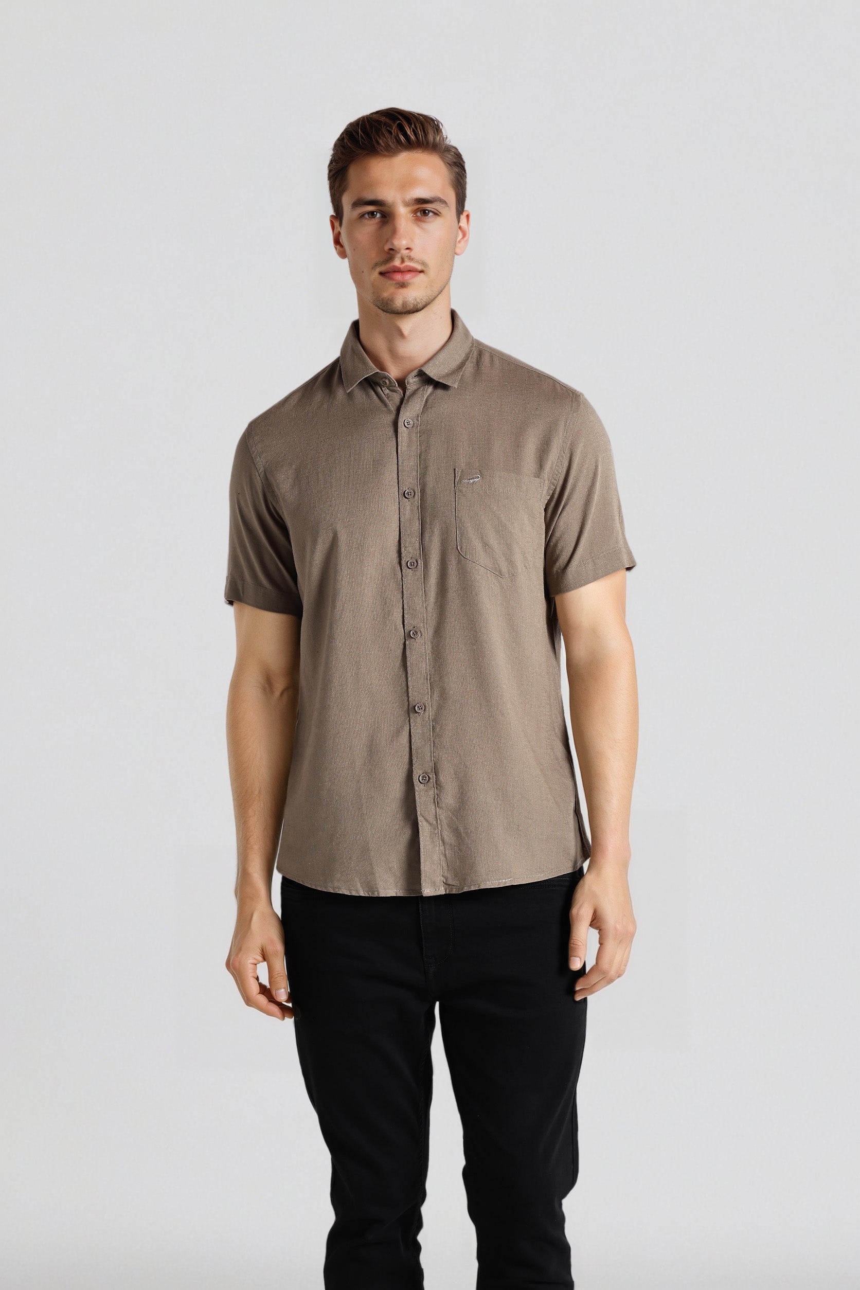 Man wearing a brown short-sleeve shirt and black pants on a white background