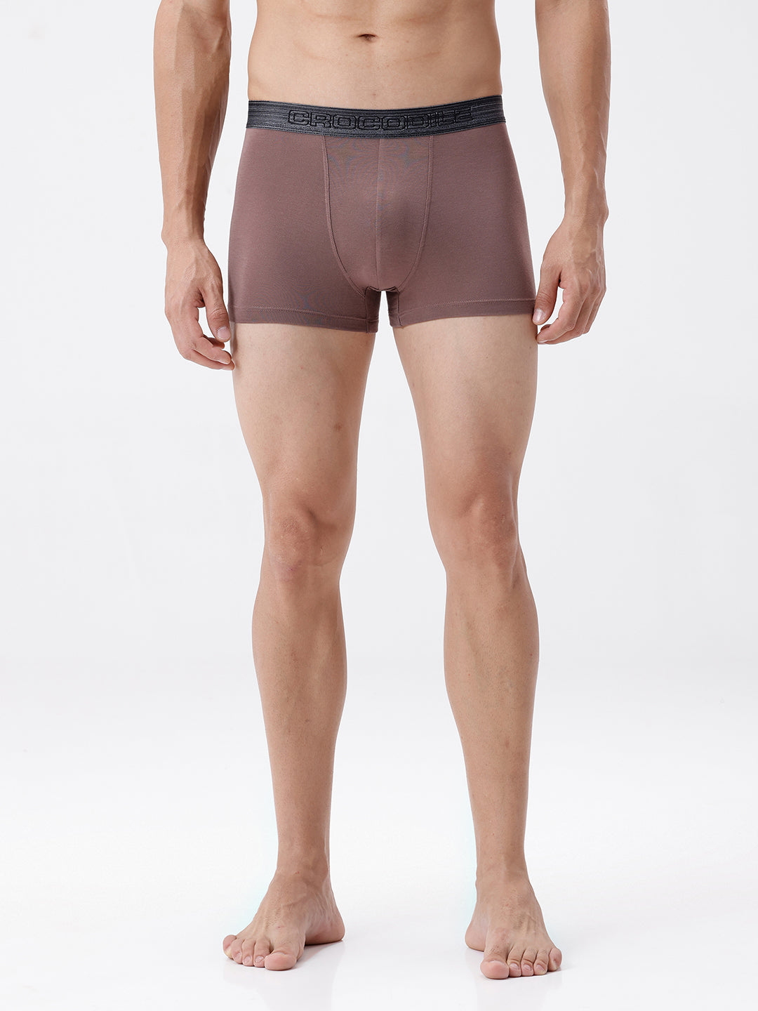 Man wearing brown boxer briefs on a white background