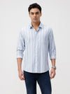 Man wearing a blue light weight sky blue stripe shirt with casual styling on a gray background