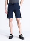 Man wearing a navy solid navy melange slim fit track shorts on a light gray background