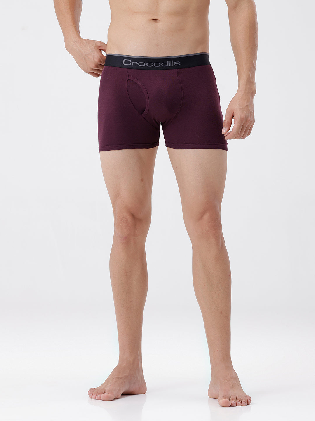 Person wearing maroon boxer briefs with a visible brand logo on a white background