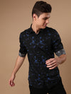 Man wearing a black black printed full sleeve casual 100% cotton shirt on a light gray background