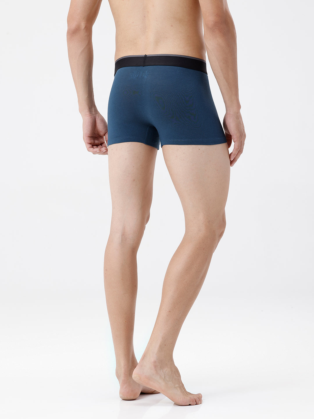 Person wearing a blue boxer brief on a white background